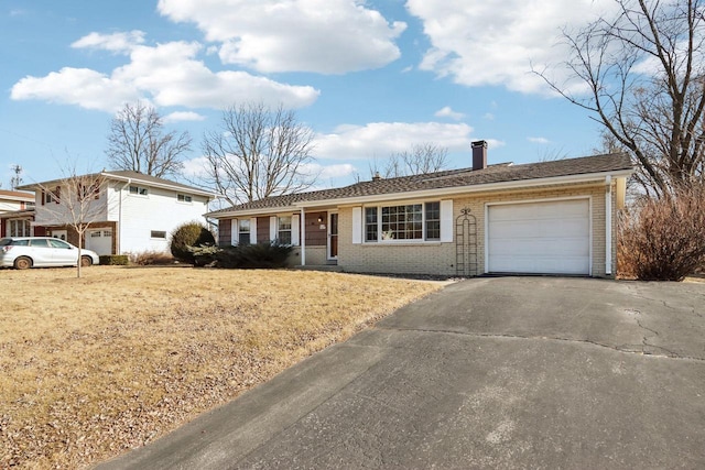 view of front of home with a garage and a front lawn