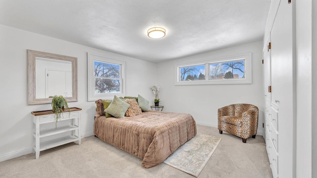 bedroom featuring multiple windows and light carpet