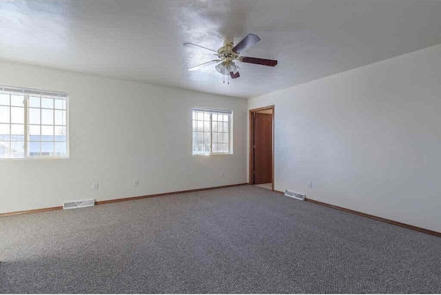 spare room featuring ceiling fan and carpet flooring