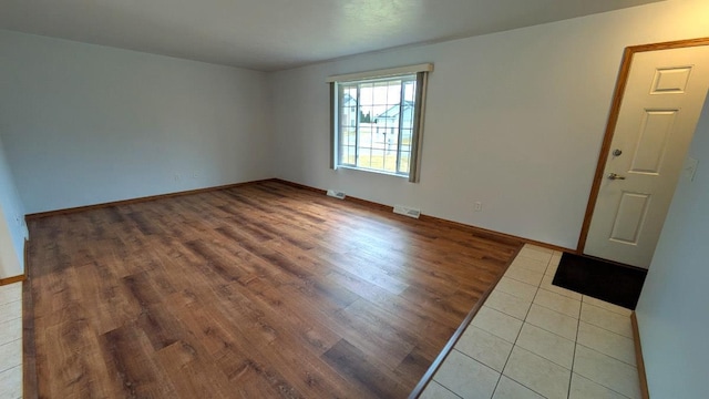 spare room with hardwood / wood-style floors