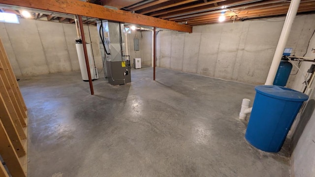 basement with water heater, heating unit, and electric panel