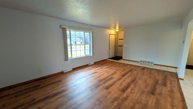 spare room with hardwood / wood-style flooring