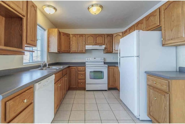 kitchen with sink, white appliances, and light tile patterned floors