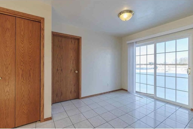 unfurnished room with light tile patterned floors