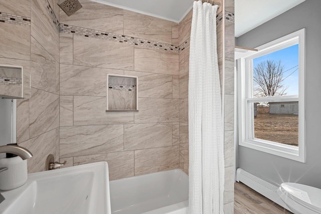 bathroom with shower / tub combo with curtain, sink, a baseboard radiator, and hardwood / wood-style floors