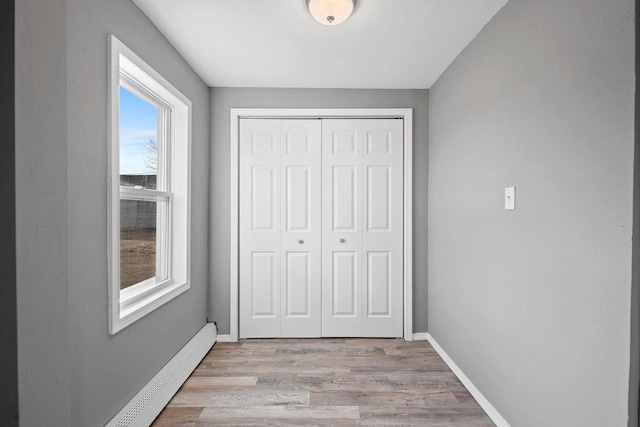 interior space with light hardwood / wood-style flooring and baseboard heating