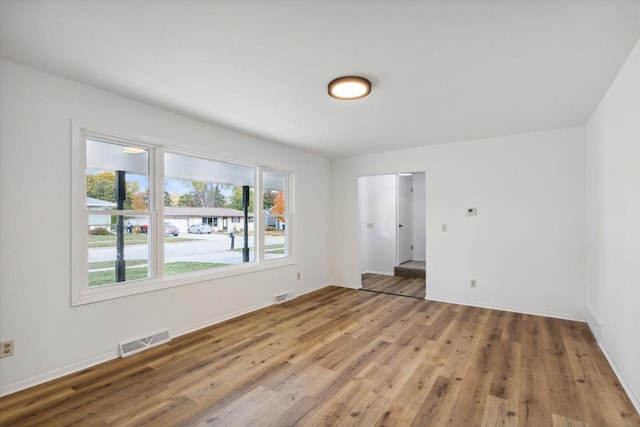 spare room with hardwood / wood-style floors