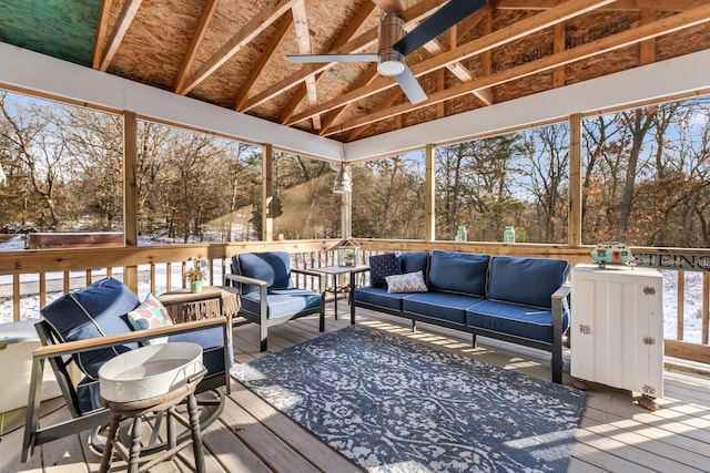 wooden deck with outdoor lounge area and ceiling fan