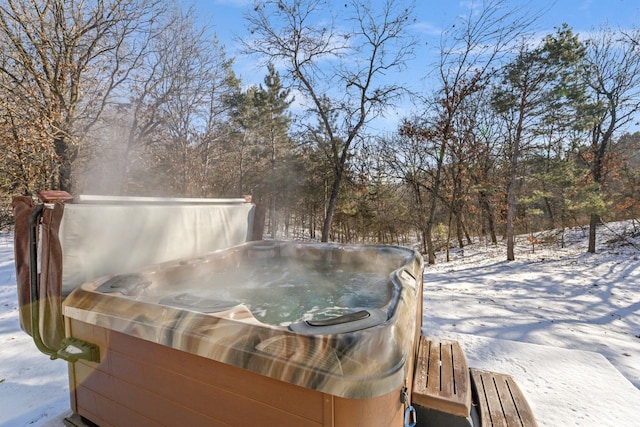 snow covered deck with a hot tub