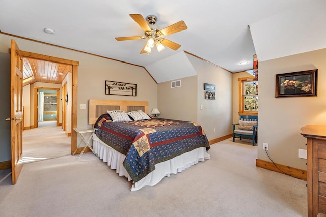 bedroom with ornamental molding, lofted ceiling, light carpet, and ceiling fan