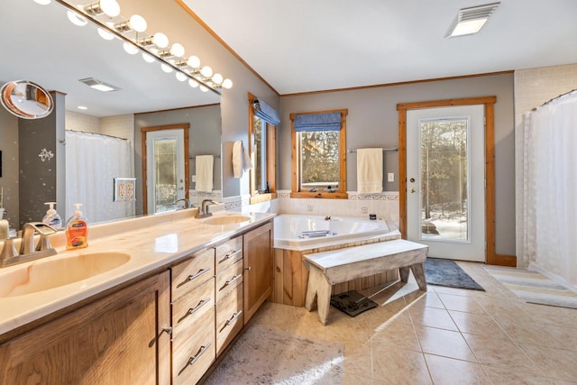 bathroom with vanity, a bath, tile patterned floors, and crown molding