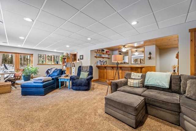 living room with carpet and a paneled ceiling