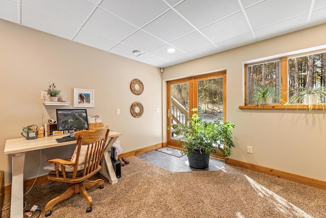 carpeted office featuring a paneled ceiling