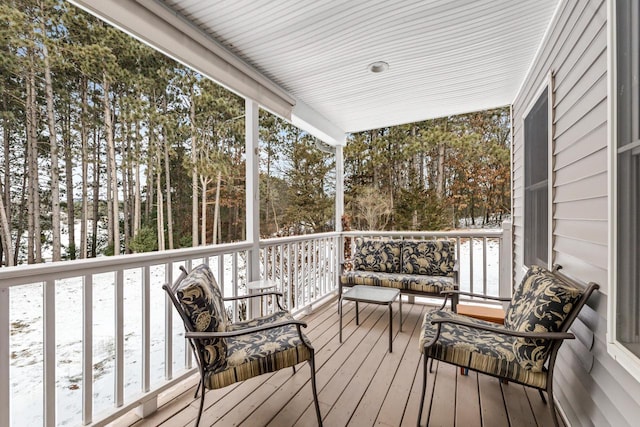 snow covered deck with covered porch