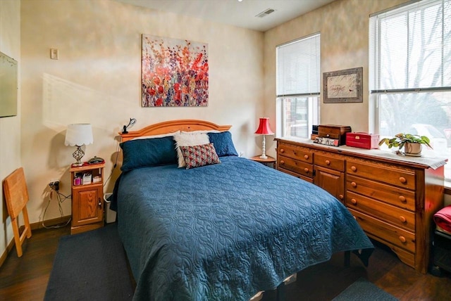 bedroom with dark hardwood / wood-style floors