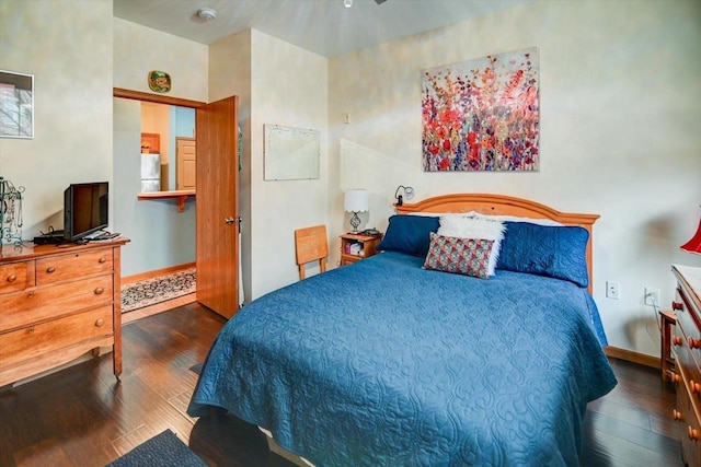 bedroom featuring white refrigerator and dark wood-type flooring