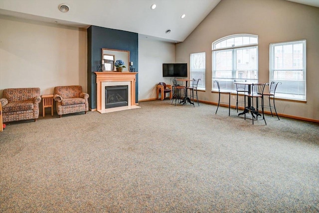 carpeted living room featuring high vaulted ceiling