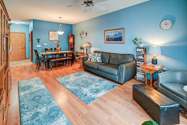 living room with ceiling fan and light hardwood / wood-style floors