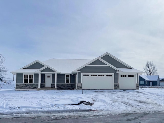 craftsman house with stone siding and an attached garage