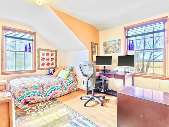 bedroom featuring hardwood / wood-style flooring and lofted ceiling