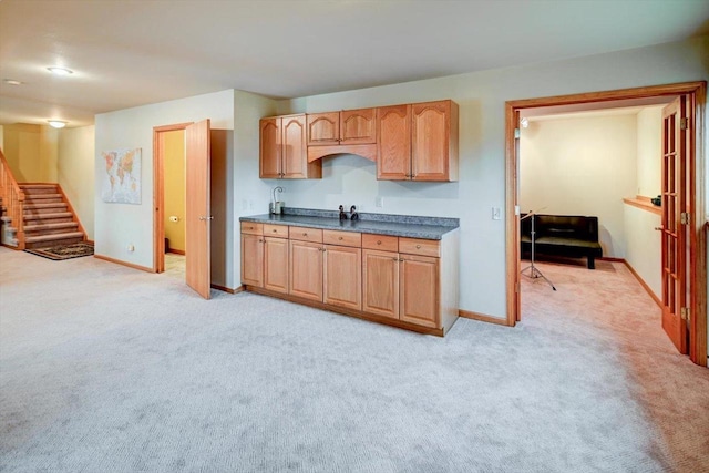 kitchen featuring light colored carpet