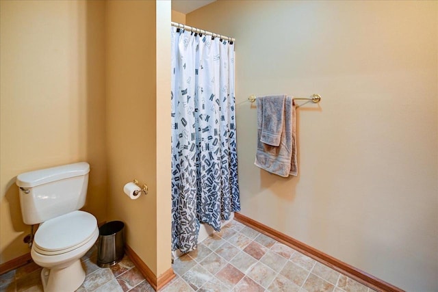 bathroom with walk in shower and toilet