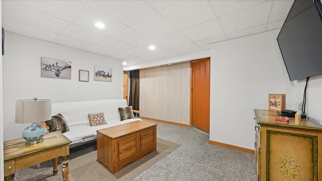 living room featuring light colored carpet and a drop ceiling