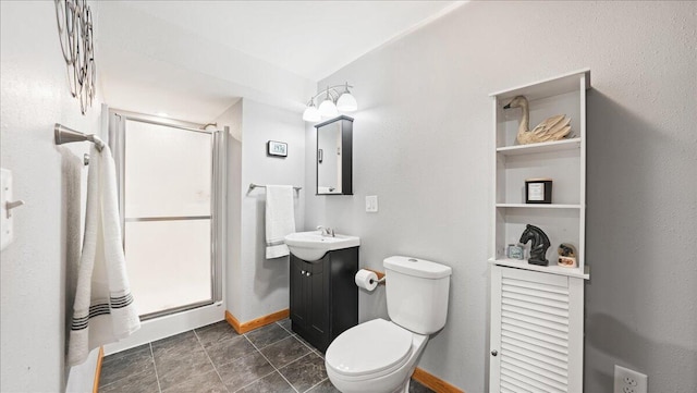 bathroom with vanity, toilet, and a shower with door