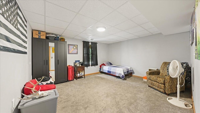 bedroom featuring carpet floors and a paneled ceiling