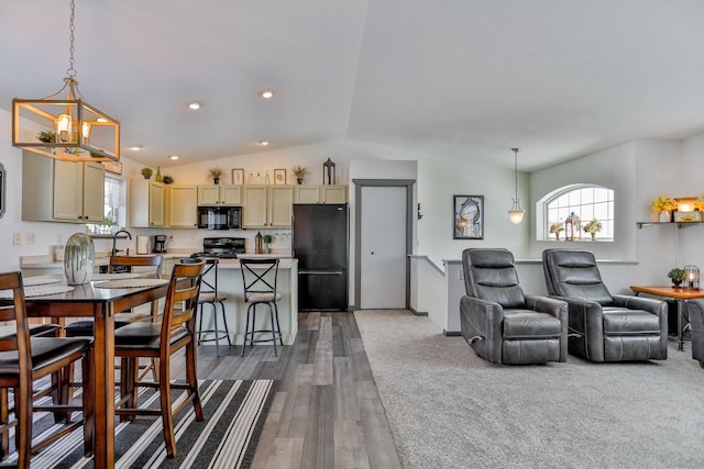 interior space featuring an inviting chandelier, dark wood-type flooring, and vaulted ceiling