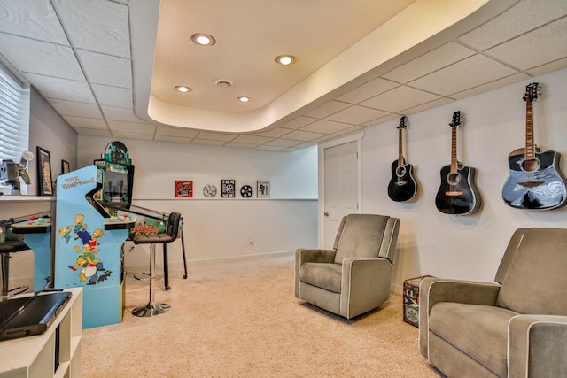 rec room featuring a paneled ceiling and carpet