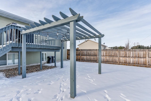 snow covered patio featuring a pergola