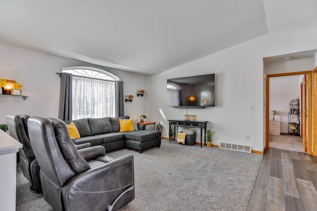 living room with vaulted ceiling and wood-type flooring