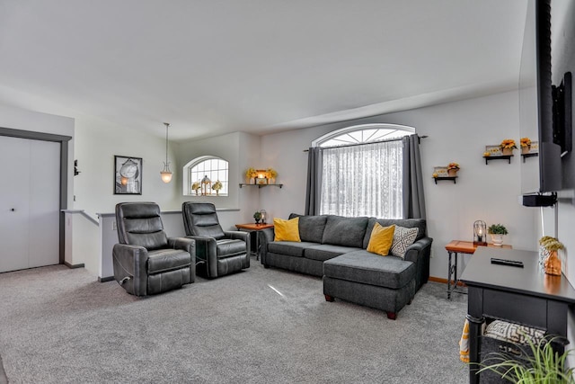 carpeted living room with vaulted ceiling