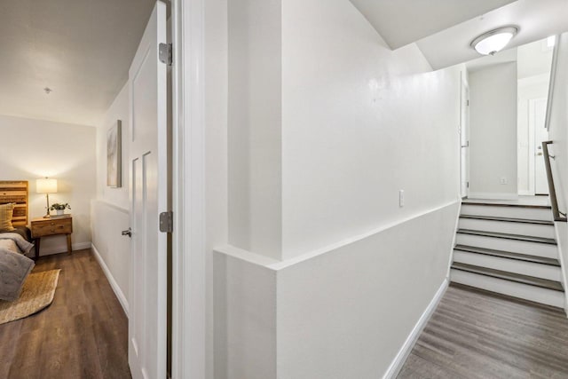 corridor with hardwood / wood-style floors