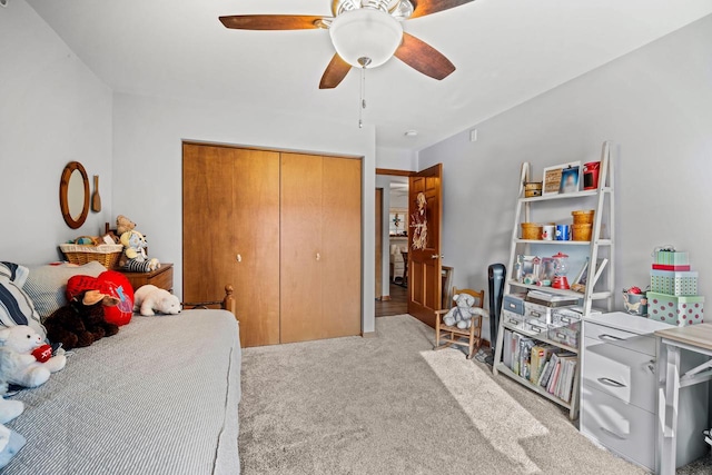 carpeted bedroom featuring ceiling fan and a closet