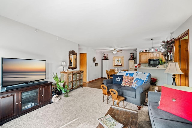 carpeted living room with ceiling fan