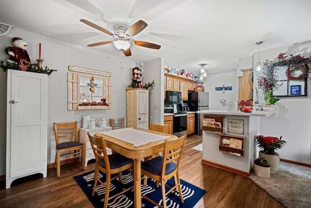 dining area featuring ceiling fan and dark hardwood / wood-style floors