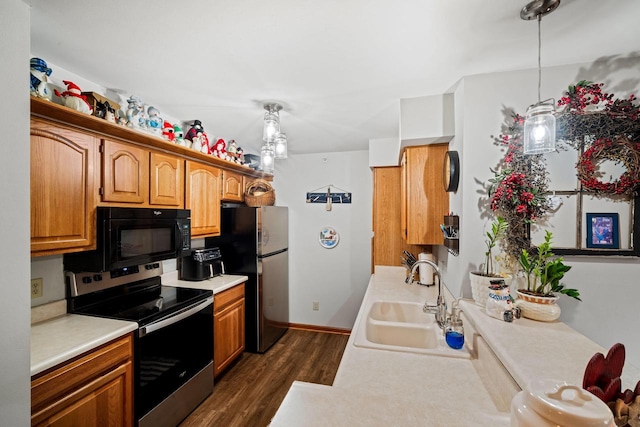 kitchen with pendant lighting, sink, dark hardwood / wood-style floors, and appliances with stainless steel finishes