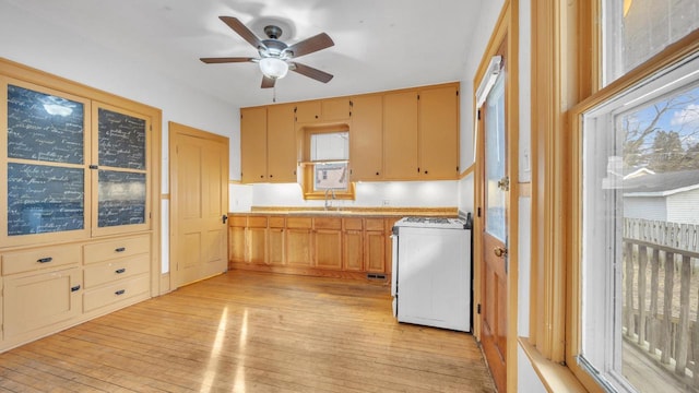 kitchen with white gas range, sink, ceiling fan, and light hardwood / wood-style flooring