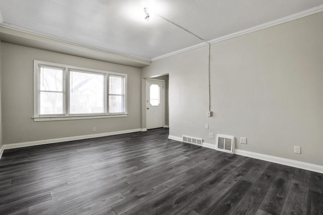 spare room featuring ornamental molding and dark hardwood / wood-style flooring