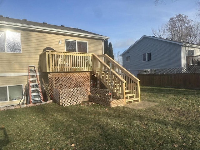 back of house featuring a yard and a deck