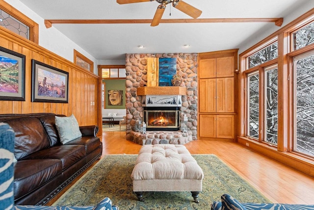 2532 Huntington Way, Suamico, WI 54173 - living room with beamed ceiling, light wood-style flooring, a stone fireplace, and ceiling fan