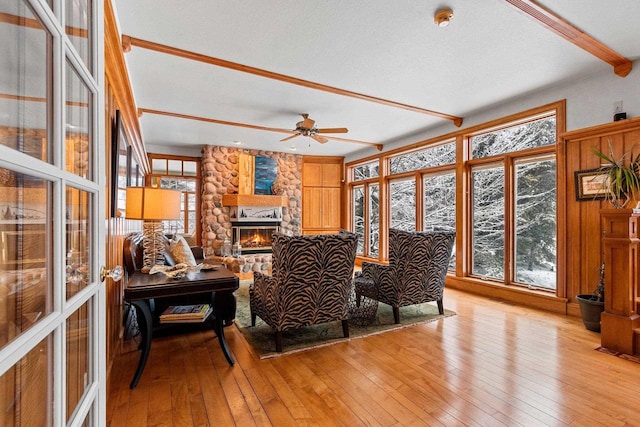2532 Huntington Way, Suamico, WI 54173 - interior space with beamed ceiling, a ceiling fan, a stone fireplace, and light wood-style flooring