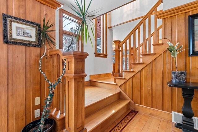 2532 Huntington Way, Suamico, WI 54173 - stairs featuring wood walls, visible vents, and wood-type flooring