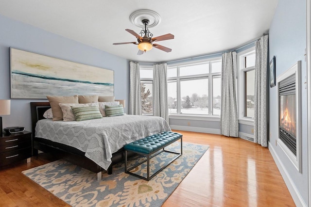2532 Huntington Way, Suamico, WI 54173 - bedroom featuring baseboards, a ceiling fan, and wood finished floors