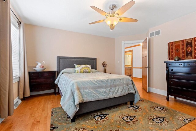 2532 Huntington Way, Suamico, WI 54173 - bedroom with baseboards, visible vents, light wood-style floors, and ceiling fan