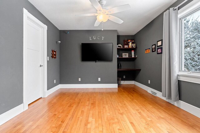 2532 Huntington Way, Suamico, WI 54173 - unfurnished living room featuring light wood-style flooring, visible vents, and ceiling fan