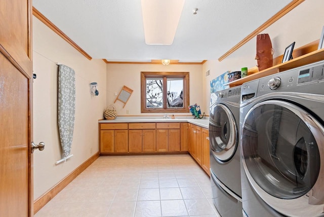 2532 Huntington Way, Suamico, WI 54173 - clothes washing area featuring light tile patterned floors, a sink, crown molding, washer and dryer, and cabinet space