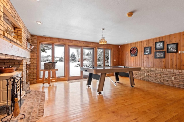 2532 Huntington Way, Suamico, WI 54173 - playroom with brick wall, a wealth of natural light, and light wood-style floors